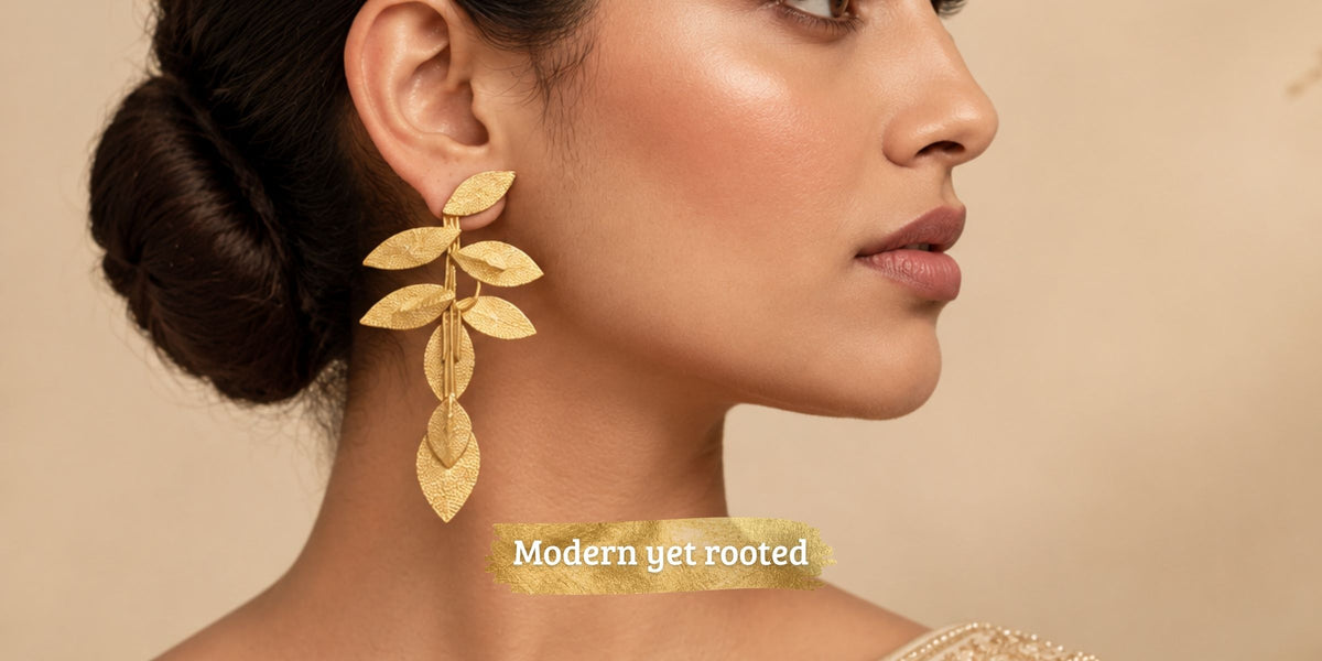 Side profile of woman wearing gold-plated leaf earrings from Ojsi